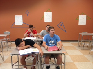 Freshman Cameron Norgren (front-right), sophomore Daniel Kasper (back-left), junior Ary Conde (back-right), and senior Tristen Pender (front-left) all experience the schoolitis in class.