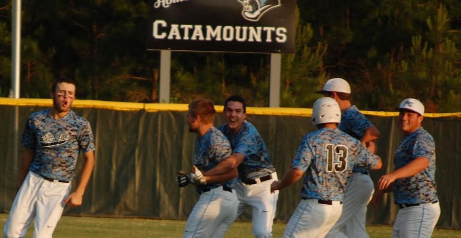 Teammates rush to celebrate with Ross Moreau after he hit his walk-off RBI