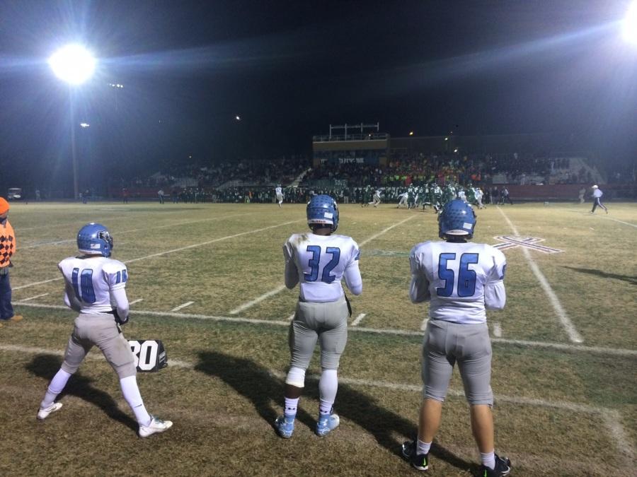 21 November 2014 - Caleb Cross ( receiving TD), Julian Wheaton (3 sacks), and Ben Williams (3.5 tackles) watched from the sideline as Panther Creek defeated Green Hope 28-7 in the second round of the NCHSAA 4AA state playoffs. 