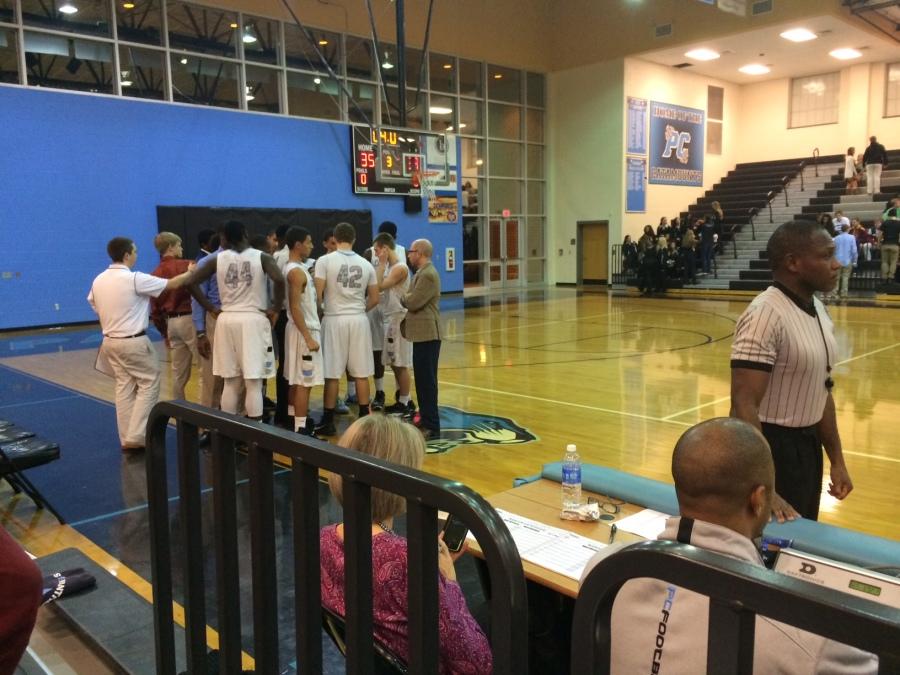 16 December 2014 - Panther Creek head coach Shawan Robinson gathers his team for a huddle early in the third quarter. Panther Creek defeated Cary 71-54 to improve to (5-6, 2-0).