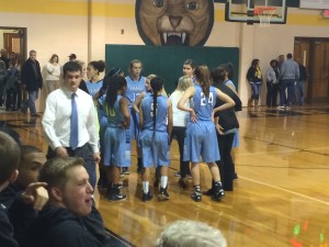 9 January 2015 - Coach Moore shares strategy with her team during the second quarter of the team's 68-41 loss to Apex. 
