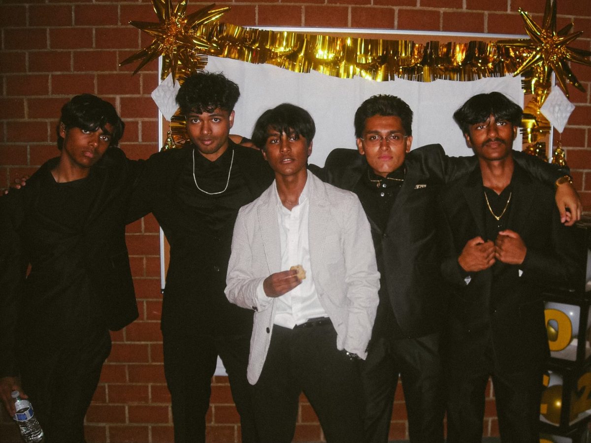 A group photo in front of one of the night's photobooths.