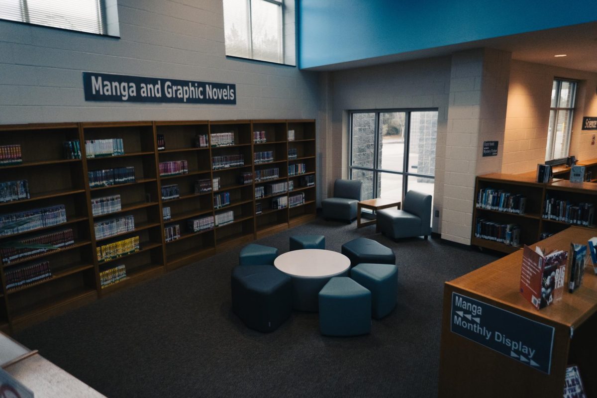 The corner of the library we recommend, with tables, chairs, and natural sunlight.